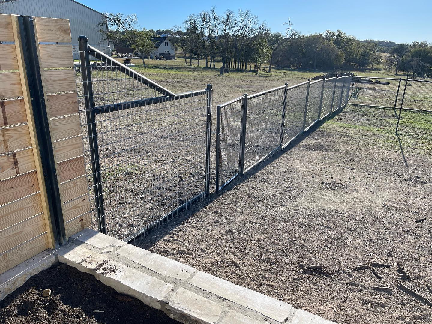 2 3/8 drill pipe top and bottom rail fence with horse panel inlay.