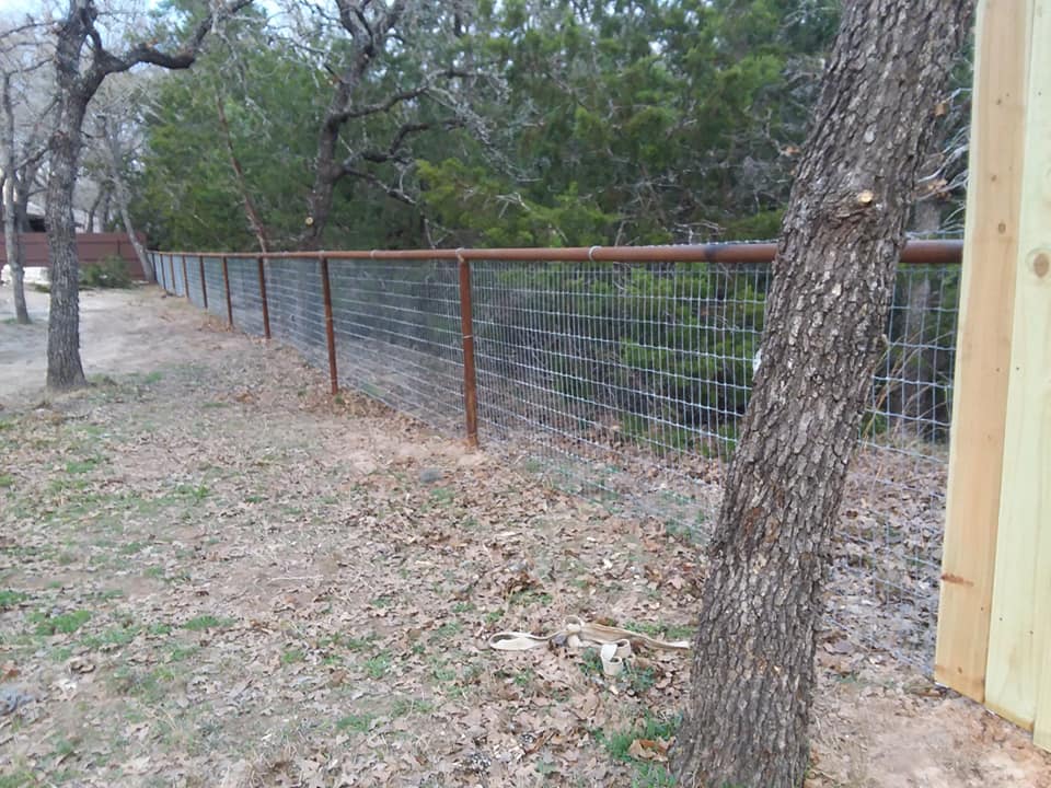 2 3/8 drill pipe top rail fence with horse panel inlay.